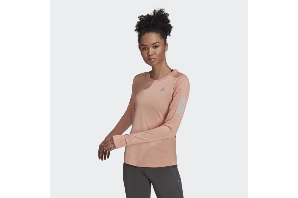 adidas Own The Run Long Sleeve T Shirt Ambient Blush Chase your runner s high all year round with the Own the Run Long Sleeve Tee. The top is cut from comfortable peach soft material