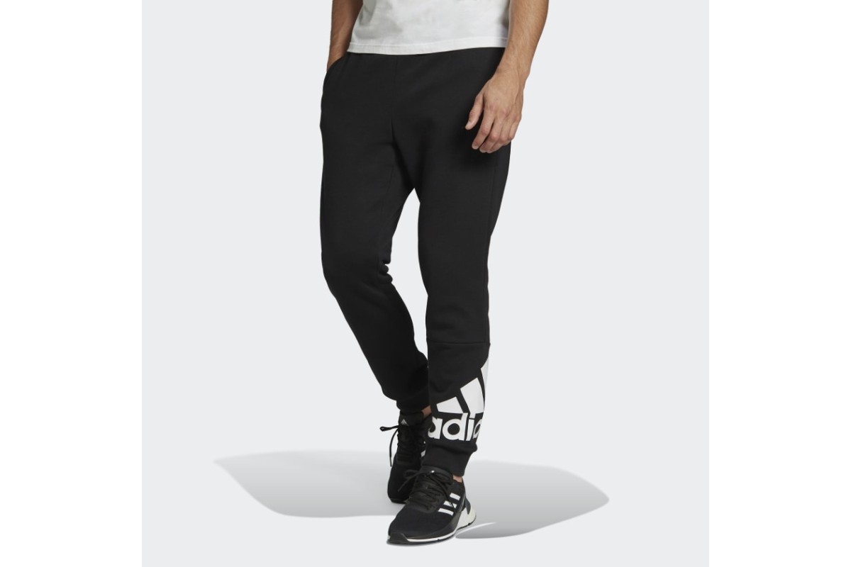 adidas Essentials Fleece Tapered Cuff Logo Pants Navy These pants are ultra  cozy and have sporty style that's undeniable. An oversize adidas Badge of  Sport and cuffed hems add to a fashion-forward