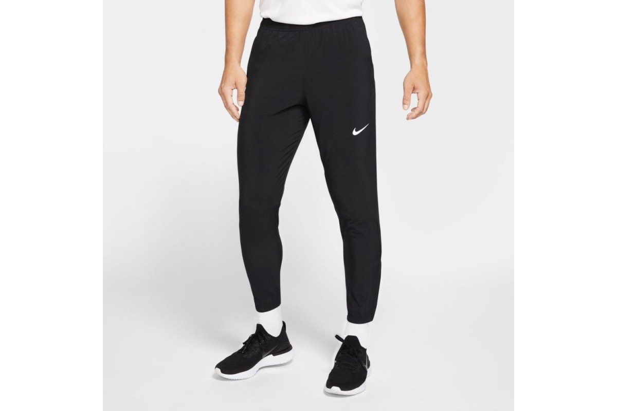 The Nike Essential Pants are your go-to for layering over shorts or wearing  solo. The lightweight, stretchy fabric drapes your legs and tapers for a  snug fit at your ankles. Zippers at